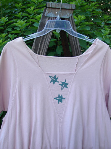 1993 Jazz Dress Star Leaf Ash Pink Size 1: A vintage pink dress with blue designs, featuring a wide A-line shape, triangular neckline accent, rear cord lacings, and signature 1993 paint and patch details.