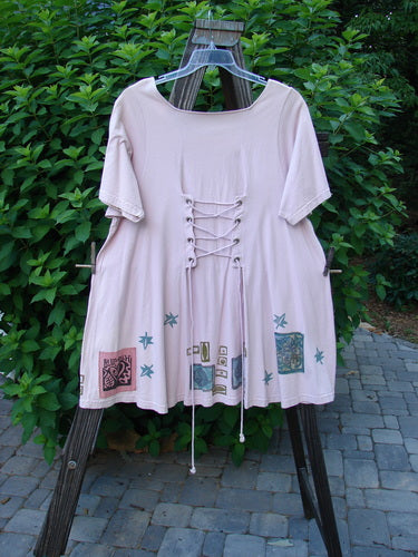 1993 Jazz Dress Star Leaf Ash Pink Size 1 on a rack, featuring a lace-up back, super wide rounded A-line shape, and unique 1993 Blue Fish Patch, in perfect condition.