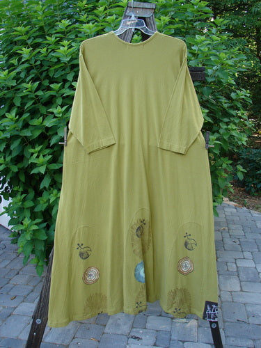 1998 Mystic Dress Celestial Terra Vert Size 2: A green dress with a super bubble hemline, rope cord tie, and abstract pinwheel theme paint.