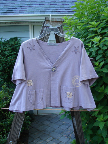 1997 Cove Jacket Star Fish Coral Reef Jasmine Size 1, featuring a flared, cropped A-line shape with a porcelain button, V-neckline, and bright blue fish patch; displayed on a hanger.