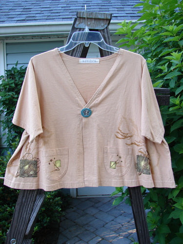 1997 Cove Jacket Sea Life Driftwood Size 1 displayed on a hanger, showcasing its flared, cropped A-line shape, V-shaped neckline, and boxy swing style, with visible handmade porcelain closure and two rounded front pockets.