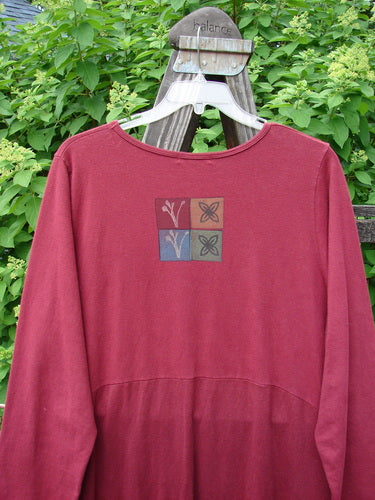 A red shirt with a square design on it, featuring the Barclay Hemp Cotton Curved A Line Dress Tree of Life Hollyberry Size 2.
