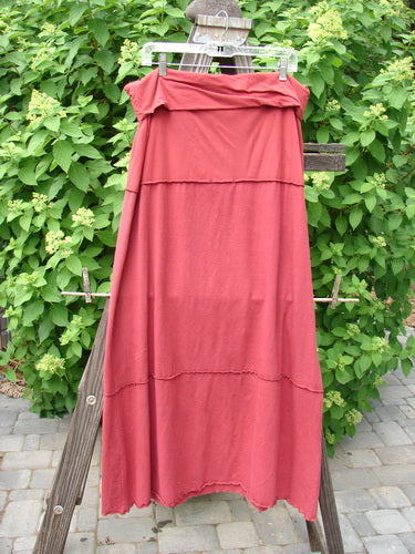 Barclay Hemp Cotton Decora Fold Over Skirt Unpainted Brick Size 2 displayed on a wooden stand, showcasing its A-line shape and generous width.