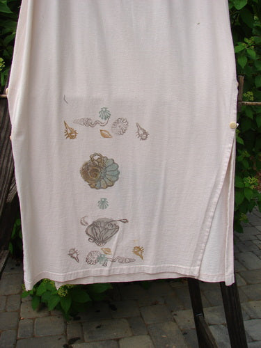 A 1994 Panel Skirt with a Daisy Flower design in Tea Dye. Made of Medium Weight Cotton Jersey. Features a Full Rear Elastic Waistline with a Sweet Longer Front Skinny Painted Panel accented by Vertically Curved Side Buttons. Size 2.
