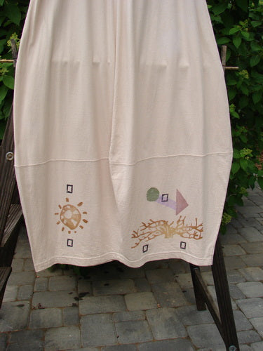 1996 4 Square Skirt Sun Sea Birch Bark Size 2 displayed on a clothes rack, showcasing its unique 4 square bottom hem and deep side pockets, made from organic cotton with a full elastic waist.