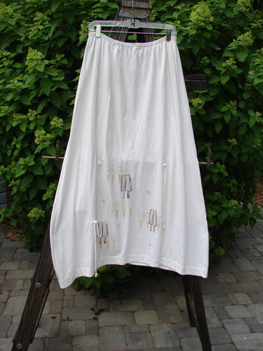 2000 Side Pocket Skirt Summer Treat White Size 2, displayed on a clothesline, showcasing its elastic waist, side pocket, and unique vertical panel design for a flowing, draped look.
