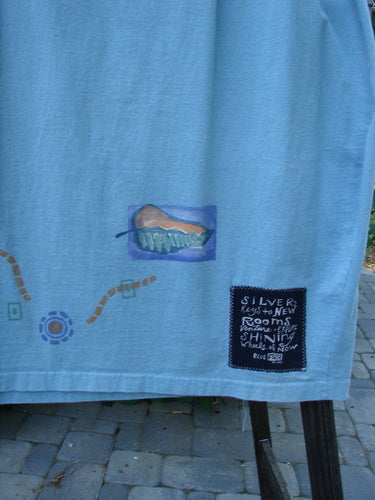 Image: A blue towel with a patch on it, featuring a drawing of a shoe, a close-up of a fence, and a close-up of a stone floor.

Alt text: 1996 Destination Skirt Travel by Path Sea Spray Size 2: Blue towel with shoe patch, fence, and stone floor details.