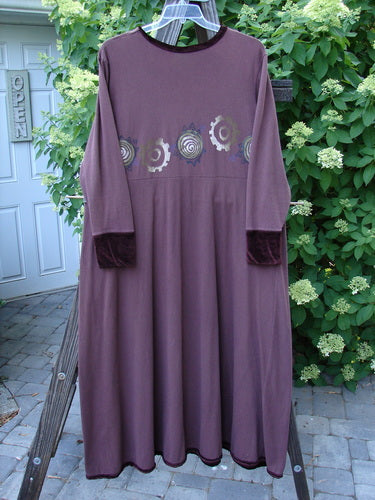 1996 Velvet Ornamental Pocket Dress Spirograph Spicewood Size 1: A purple dress with a design on it, featuring a velvet-accented neck, hem, and sleeve trim.