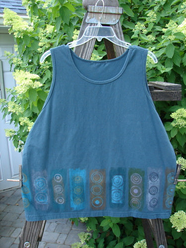Barclay Cotton Lycra Summer Tank Continuous Puddle Size 1 displayed on a swing, featuring a round neckline, medium weight fabric, and tapered lower shape.