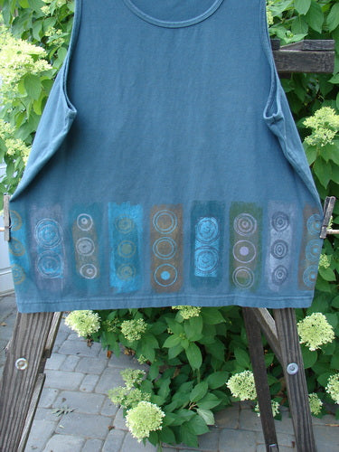 Barclay Cotton Lycra Summer Tank Continuous Puddle Size 1 displayed on a wooden ladder, showcasing a rounded neckline and tapered lower shape, designed in a triple vertical pattern for Bluefishfinder.com.