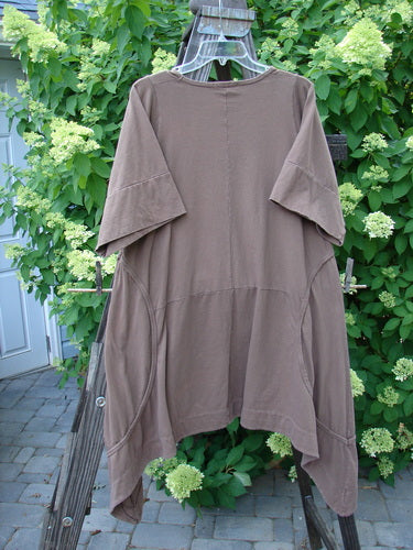 Barclay Double Pocket Bounce Tunic Dress Unpainted Mushroom Size 1 displayed on a rack, showcasing wrap-around side seams, oversized front pockets, and an upward scooped hemline.