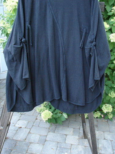 Barclay NWT Hemp Cotton Tidal Jacket Roses Black Size 2, featuring oversized buttons, unique S curved seam, exterior drop pockets, and decorative ties on forearms, displayed on a clothing rack.