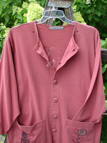 1996 Elements Everyday Jacket Primitive World Ember Size 1 displayed on a hanger, showcasing scribe buttons, oversized exterior drop pockets, and minor neckline fade on mid-weight organic cotton fabric.