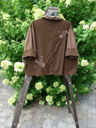 1997 Corduroy Mason's Jacket Structural Lumber OSFA displayed on a wooden stand, featuring a folded neckline, front painted pockets, cuffed cord sleeves, and detailed metal buttons with rivets on pocket edges.