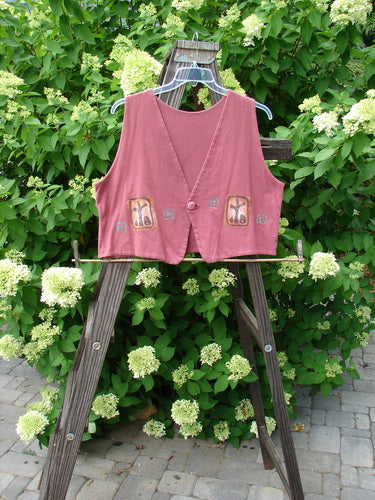 1996 Simple Vest Primitive Ember OSFA displayed on a wooden stand, featuring a deep V-neck, scooped back hemline, etched button closure, and signature Blue Fish patch with a primitive theme paint design.