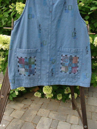 Image: A blue jean skirt with a patchwork design on it, displayed on a stone surface.

Alt text: Barclay Canvas Urban Pocket Apron Jumper, blue jean skirt with patchwork design, displayed on stone surface.