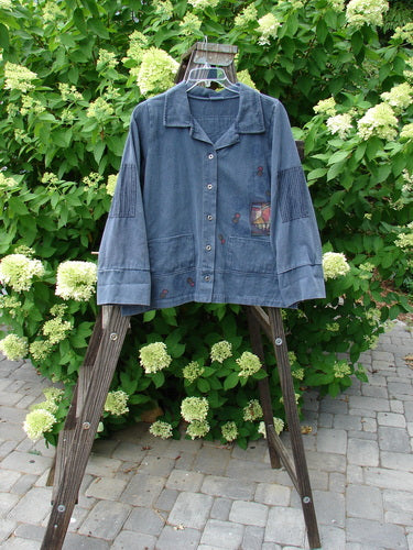 Barclay Patched Open House Canvas Barn Jacket Power Village Blue Jean Stripe Size 1 displayed on a wooden hanger in an outdoor setting with visible patch accents and a stand-up collar.