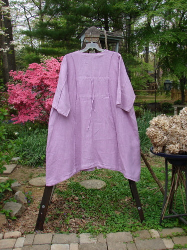 Barclay Linen Double Tie Back Jacket Garden Side Lilac Size 2 displayed on a mannequin outdoors, showcasing its deep V neckline, vertical stitchery, and front drop pockets.