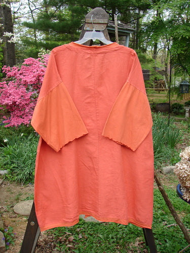 Barclay NWT Linen Cotton Sleeve Pocket Cardigan Contrast Unpainted Clementine Size 2 displayed on a mannequin, showcasing its wooden-like buttons, upward curved hemline, and drop front squared off pockets.