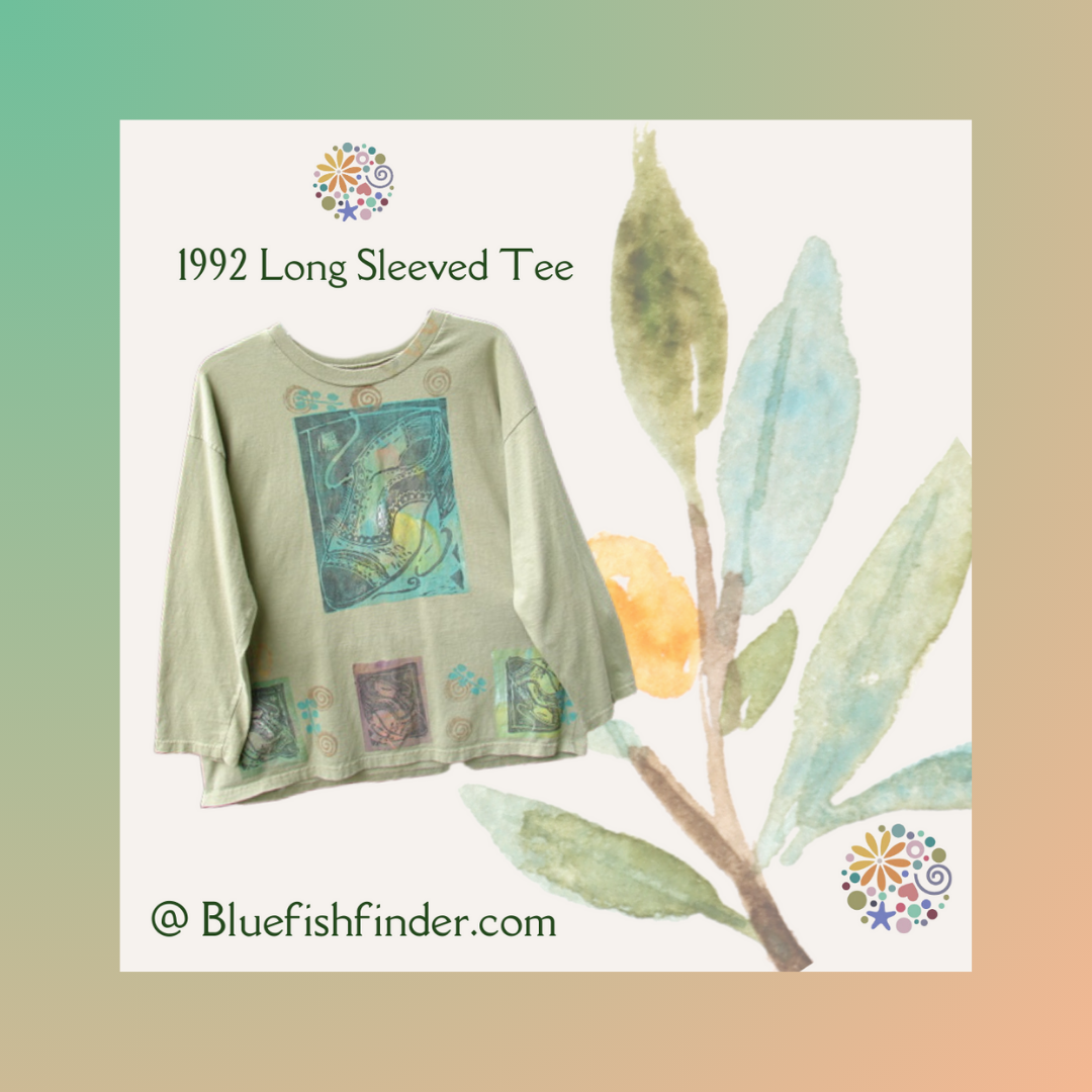 A long sleeved shirt with shoe art and a watercolor branch background is surrounded by a pastel gradient Frame. The tee one huge center block print with lower additional prints. The Blue Fish Finder Circle logo graces the lower right corner of the frame.