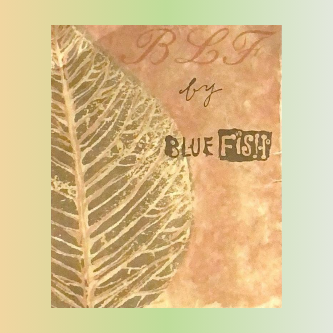 A close-up of a leaf with text and handwriting on paper in pastel pallet of natural greens and oranges Rediscover vintage Blue Fish clothing at Bluefishfinder.com.