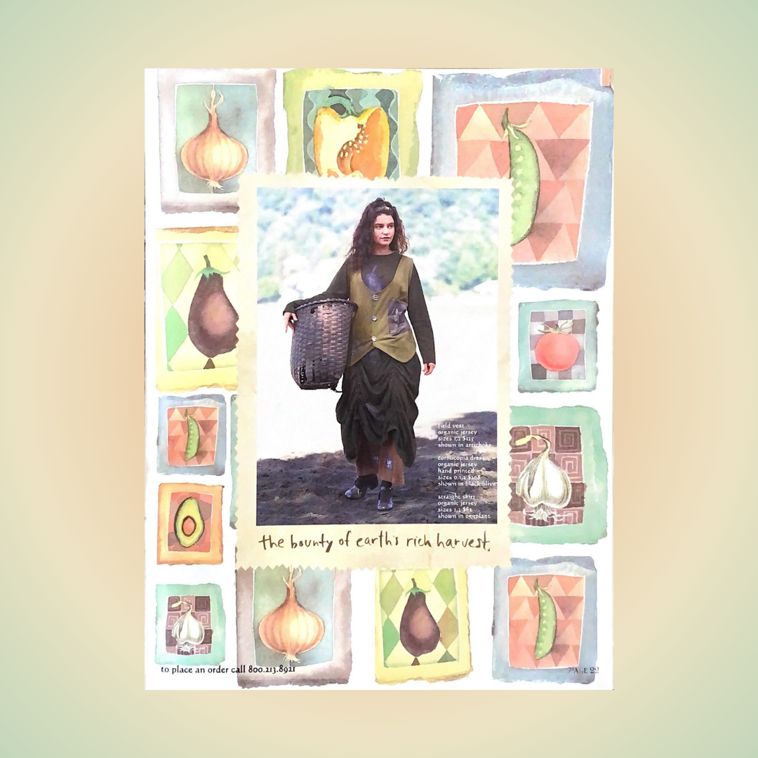 A woman carrying an oversized woven basket walks a dirt road with a crop vest in artichoke and dark green pull up skirt Around the border is vegetable harvest drawings in pastel colors advertising the Resort collection of 1998 in the harvest theme. 