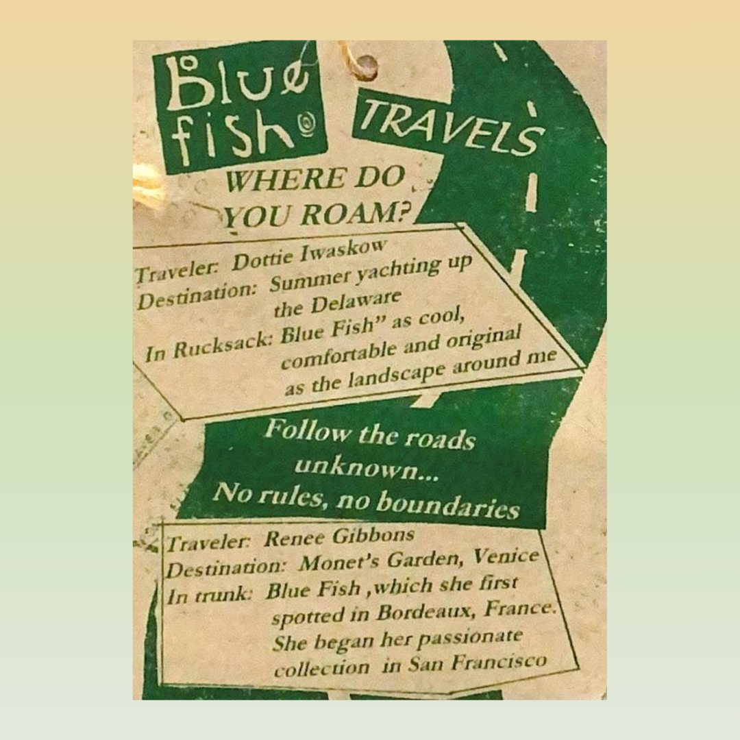 A green clothing hang tag with white and green text, featuring a road advertising travel and the unknown.