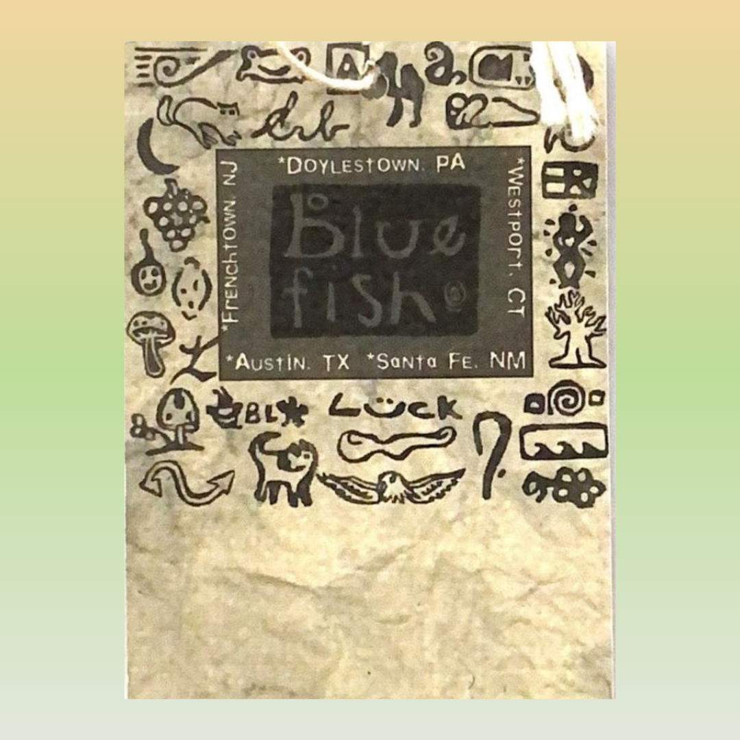 A clothing hang tag with a black square featuring artist stamps with store location text from the Blue Fish Clothing Company