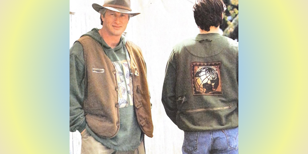 A 1998 Fall example, featuring a man standing next to another man, wearing a vest and a green sweatshirt with a picture of the earth on the back. The image also includes a close-up of a globe and a person wearing a hat and jacket and huge center art.
