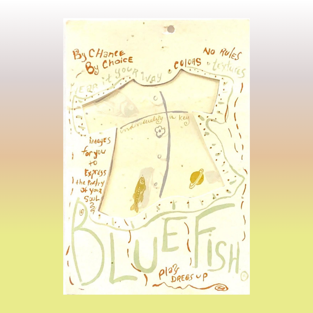 Vintage looking green and sand Blue fish tag with a two lane road and tiny text about dreams and beliefs.