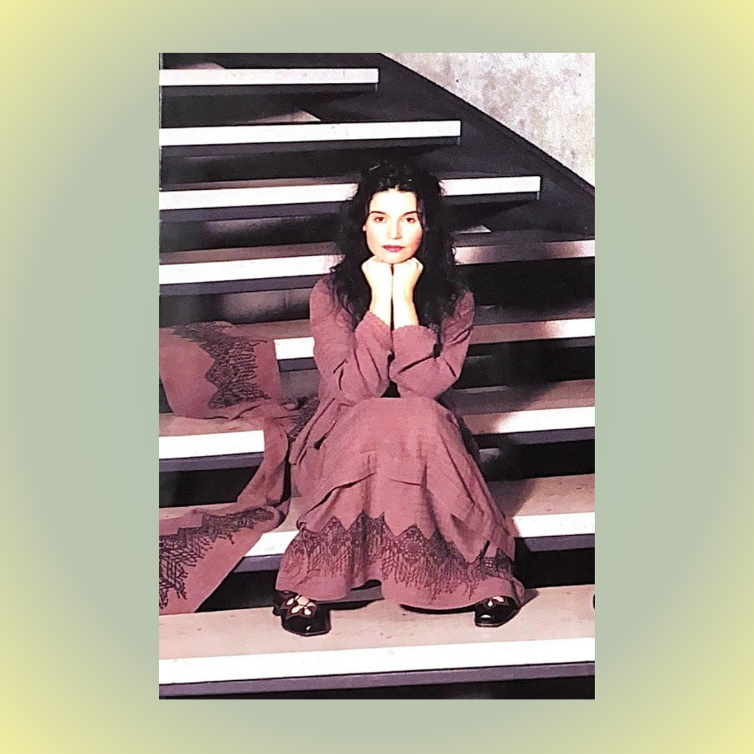 A woman sitting on stairs, wearing vintage Blue Fish clothing from the Summer Collection of 1998 featuring the Basket Weave fabric only at Bluefishfinder.com.