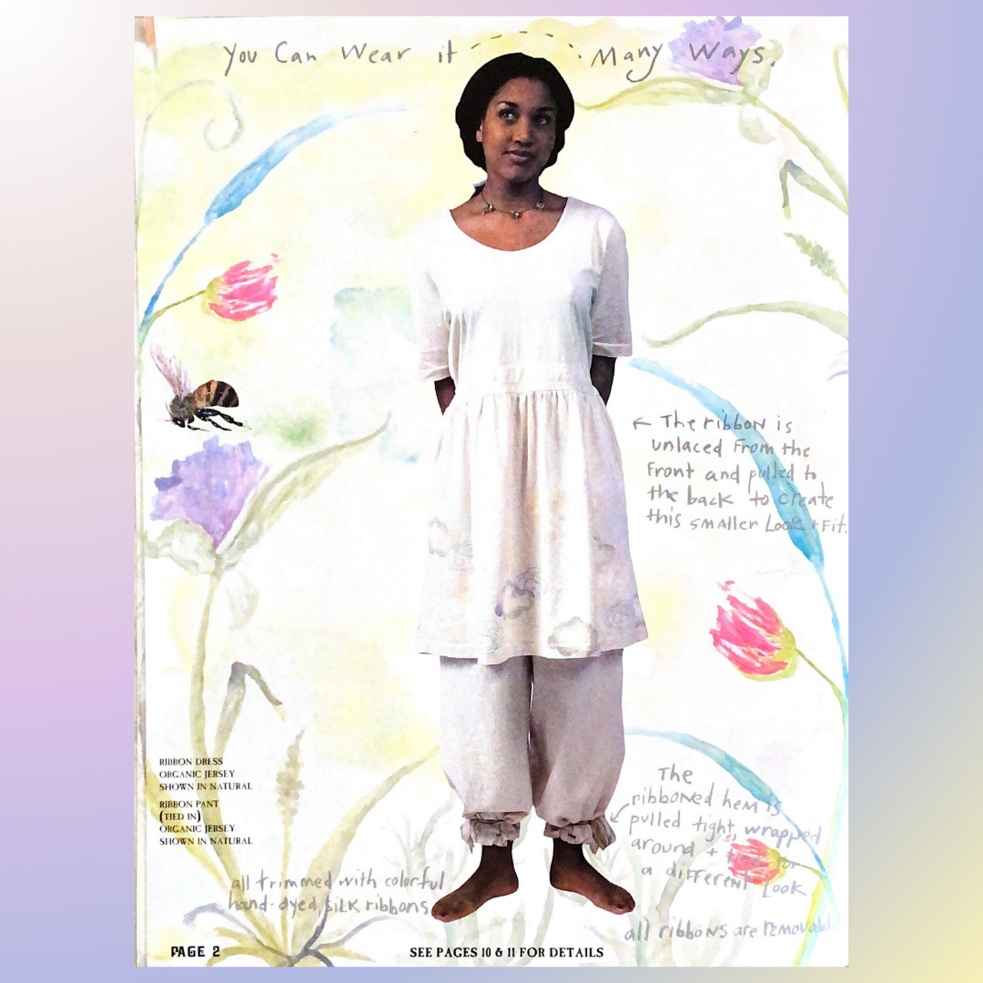 A unique New with tags vintage dress from the Summer collection of 1992 in cucumber on a large wooden hanger with black contrasting side branches showcasing a timeless design of hand blocked roses from Bluefishfinder.com.