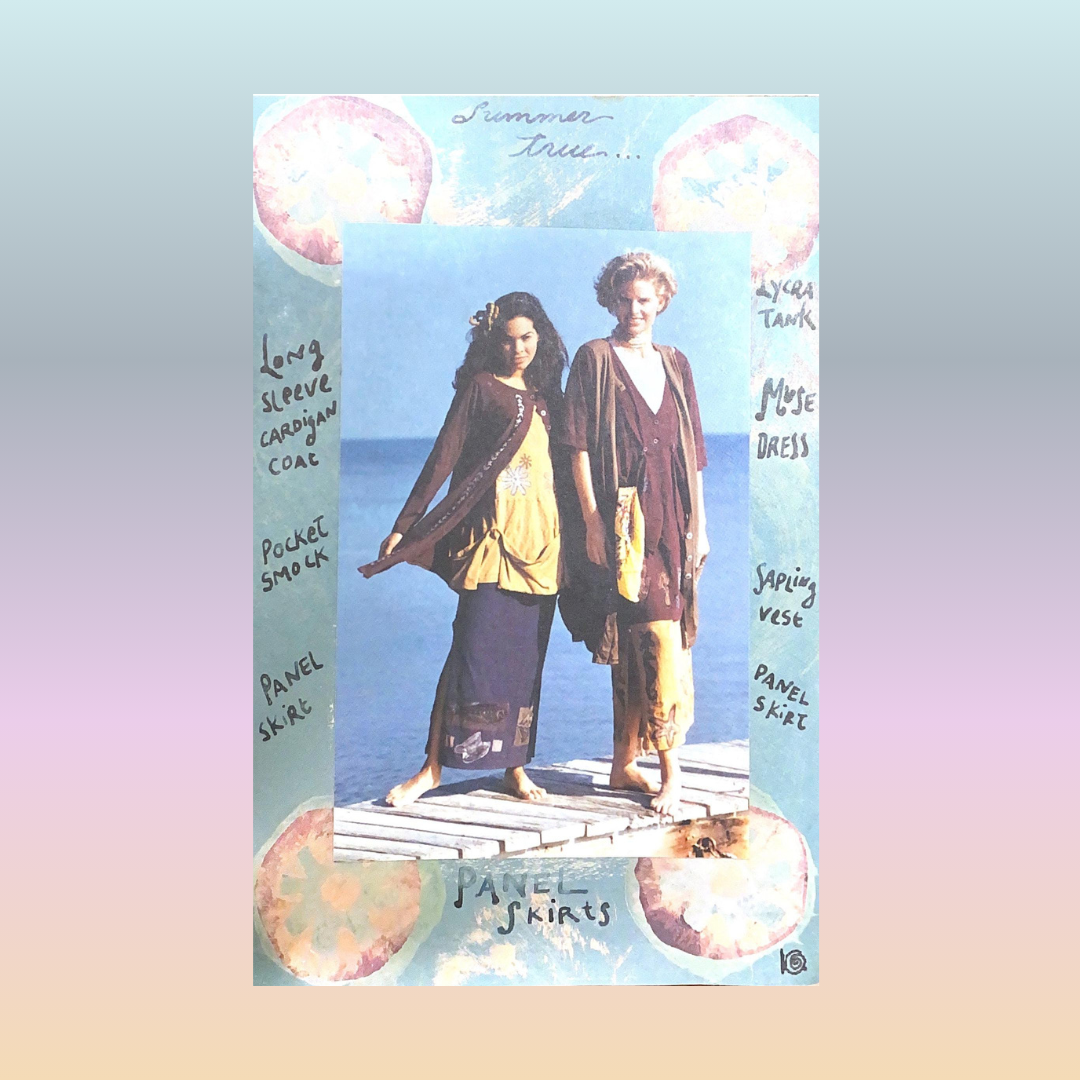 Two models sport the stronger colorway offered in the transitional collection from 1994. They stand on a skinny dock each wearing layers of Blue Fish Clothing. A few include: The elfin dress, straight skirt and pocket smock. Rounded clouds float above.