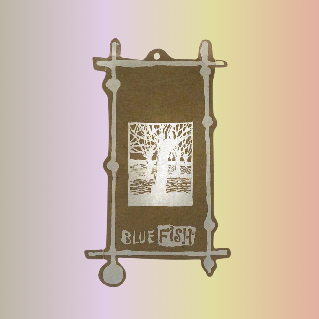A Blue Fish Hang tag in brown with a silver forest tree in the night and varying length borders invites shoppers to view unique vintage pieces from Blue Fish Clothing. Rediscover or explore this legendary, magical clothing line today!