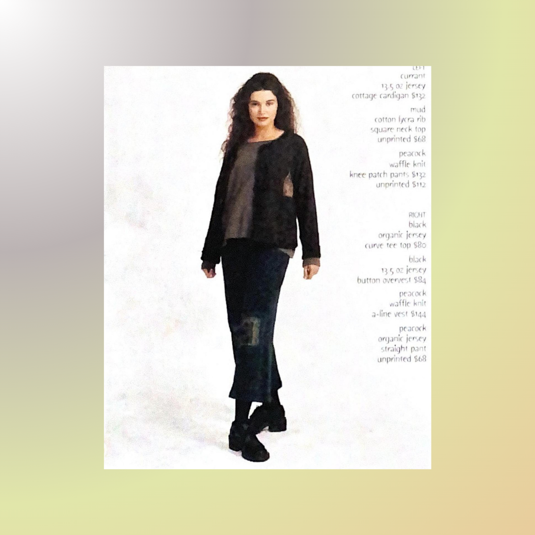 A model displays the thermal collection from Fall 1999. Her stance resembles a ballerina as he toe turns outward, hands at her side and leaning back a touch. She has full dark hair and the pant is ankle length showing her platform shoe and sock.