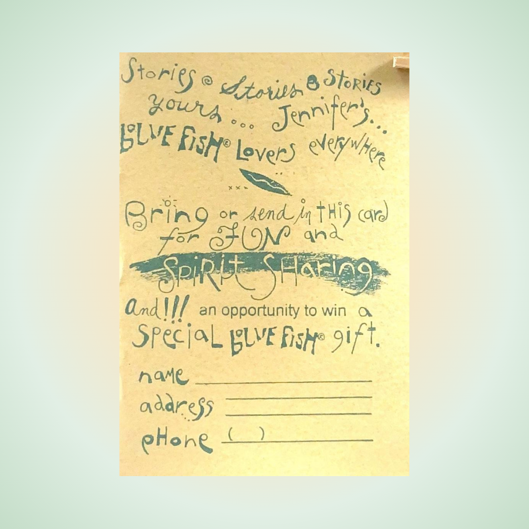 Hand-lettered promotional postcard for Blue Fish®, featuring text about spirit sharing and a prize opportunity, with stylized fish illustration and brush-stroke flourishes. Includes fields for name, address, and phone number.