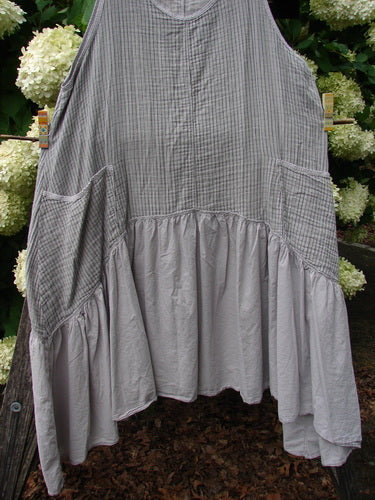 Barclay Gauze Batiste Summer Frock Jumper Stripe Light Stone Size 1 in light stone, made from gauzy batiste with a fine stripe pattern and a softly textured surface. The sleeveless frock jumper drapes in a loose A-line shape with gathered side panels and a ruffled hem.