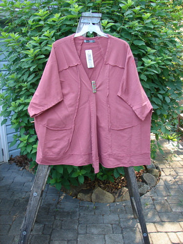 Barclay NWT Photogram Open Front Jacket in Walt Whitman Script Desert Rose OSFA displayed outdoors, showcasing its wide three-quarter sleeves, angular hem, and raw edges with a boxy, flowing silhouette.