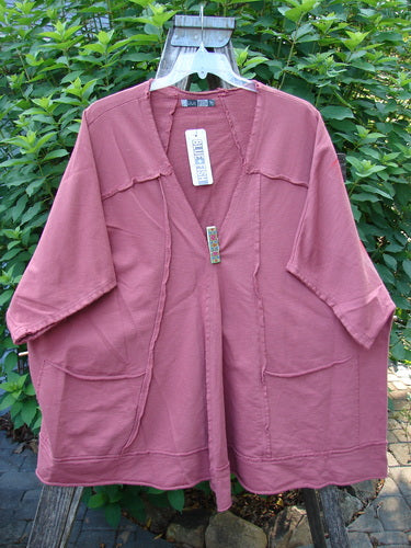 Barclay NWT Photogram Open Front Jacket in Walt Whitman Script and Desert Rose features wide three-quarter sleeves, angular hem, and dolman shoulders, displayed on a swinger, showcasing its unique design.