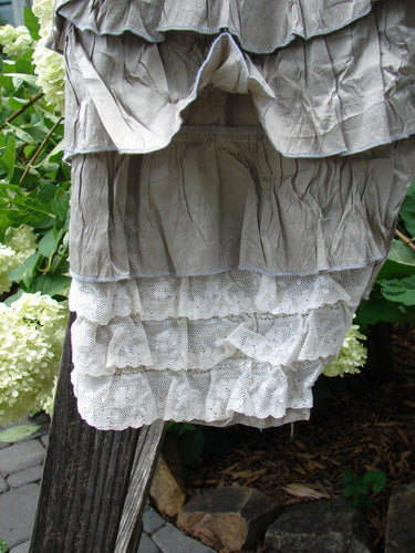 Magnolia Pearl Silk Voile Lace Alice in Wonderland Bloomer Silver Moss OSFA hanging on a clothesline, showcasing intricate lace details and delicate white flower accents.