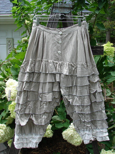 Grey ruffled Magnolia Pearl Silk Voile Lace Alice in Wonderland Bloomer Silver Moss OSFA hanging on a clothesline, with visible delicate fabric and intricate lace detailing.