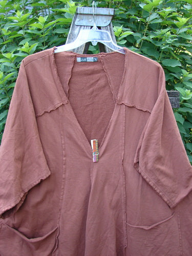 Barclay Photogram Open Front Santa Fe Jacket Garden Scrape Desert Clay OSFA displayed on a hanger, featuring three-quarter sleeves, an angular hem, and raw edges, highlighting its unique boxy, flowy design.