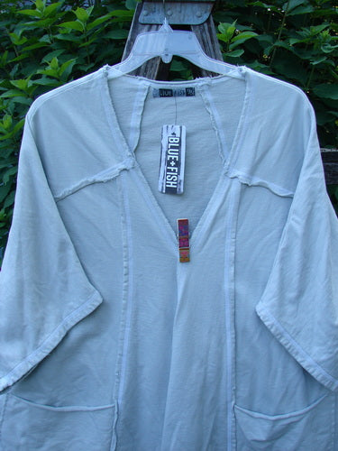 Barclay NWT Photogram Open Front Jacket Unpainted Dew OSFA displayed on a hanger, highlighting its wide three-quarter sleeves, angular hem, raw edges, and dolman shoulders made of heavyweight French terry.