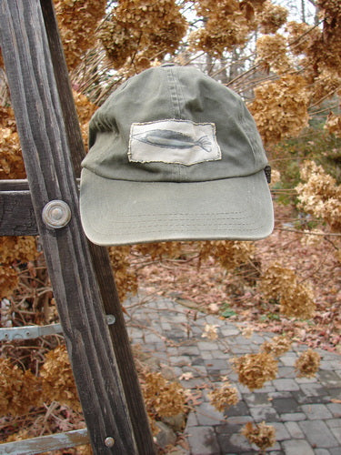 1999 Patched Men's Baseball Cap with Fish Logo on Forest Hat on Ladder. Vintage collectible in perfect condition.