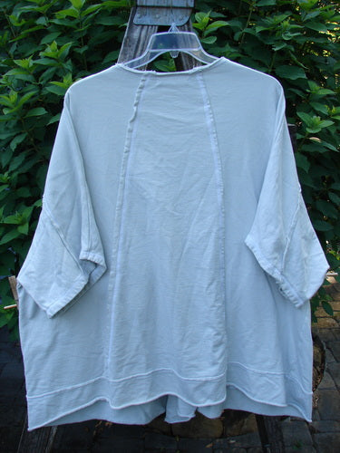 Barclay NWT Photogram Open Front Jacket Unpainted Dew OSFA showcased on a hanger, highlighting its wide three-quarter sleeves, open front, raw edges, and distinctive dolman shoulders, embodying a vintage, creative style.