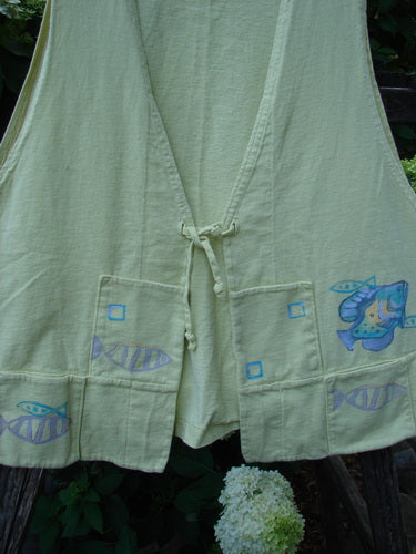 1999 Fishing Vest Fish School Citron Size 0, featuring painted fish design, tie front, squared pockets, deeper arm openings, A-line flare, and special rear pocket. Made from organic cotton, perfect condition.