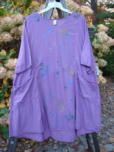Barclay NWT Batiste Bliss Dress with strawberry-themed art, short sleeves, and exterior pockets on a clothes rack. Size 2.
