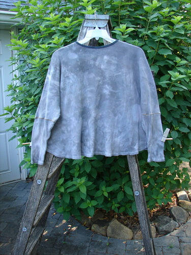 Barclay Thermal Crop Top Belief Spirit Mottled Plum River OSFA displayed on a wooden ladder, showcasing its rounded neckline, varying hem, and waffle texture.