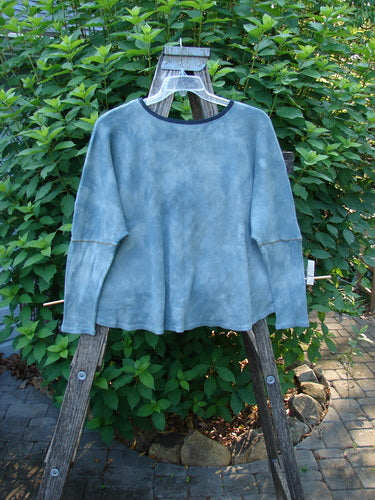 Barclay NWT Thermal Crop Top Love Dove Mottled Top Lake OSFA displayed on a wooden stand, showcasing drop shoulders, A-line flair, and varying hem with contrasting stitches in super soft waffle texture.