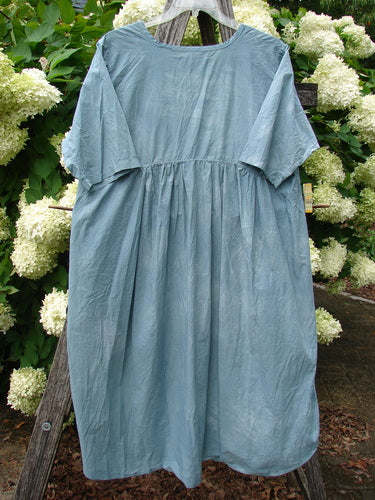 Barclay Percale Key Pocket Hi Low Dress in mottled blue cloud, size 0, shown as a loose percale dress with a softly gathered waist, short sleeves, and a rounded neckline. The lightweight fabric has a crinkled matte texture and hangs in a draped, airy silhouette.